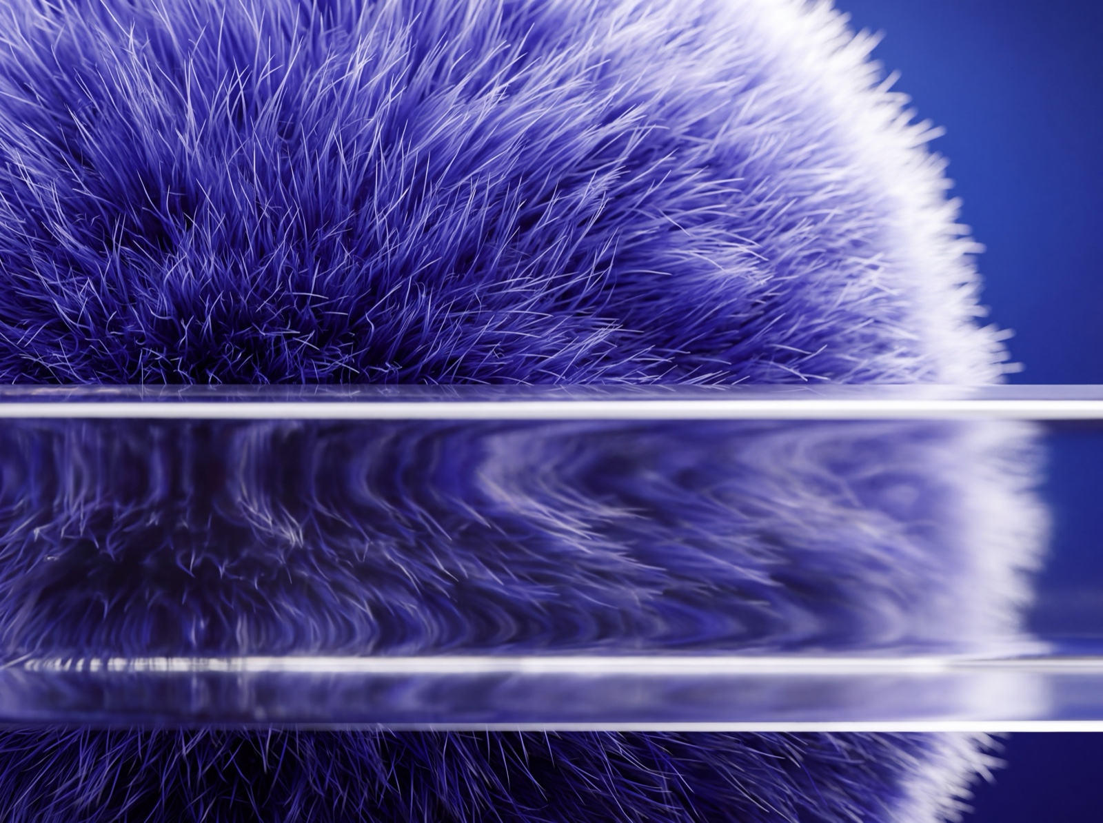 Close-up of a fur sphere behind a clear glass bar that refracts it