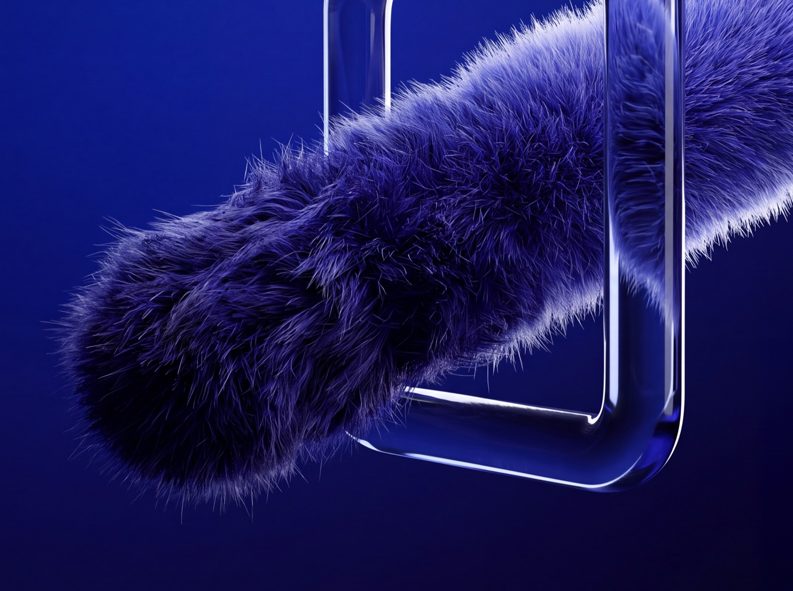 Close-up of a fur capsule passing through a glass frame — worn fur before the frame, renewed behind it